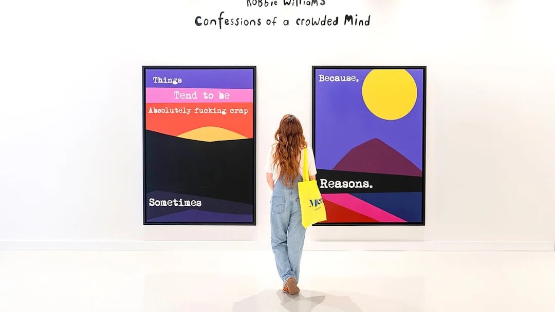 Visitor viewing colorful artwork at Moco Museum Barcelona exhibition.