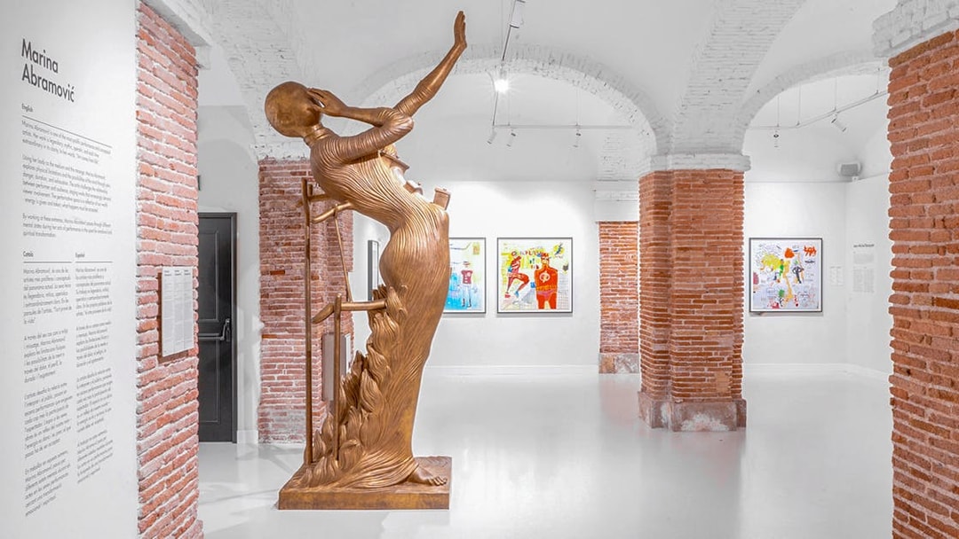 Bronze sculpture and artworks in Moco Museum Barcelona exhibition space.