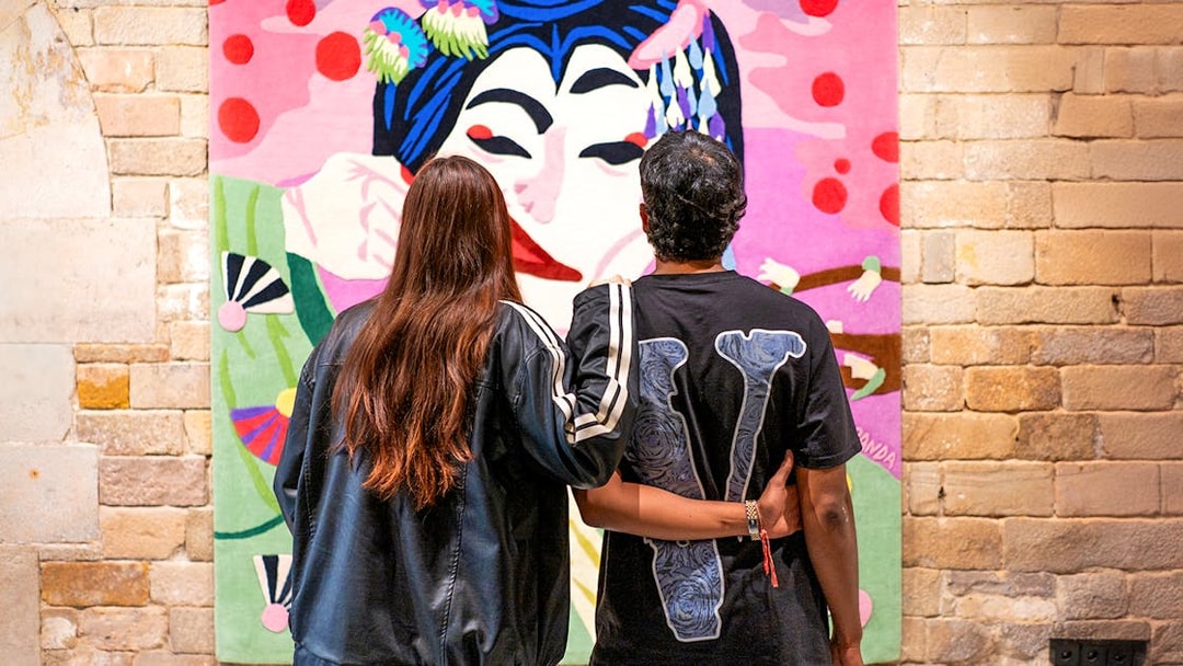 Visitors admiring colorful artwork at Moco Museum, Barcelona.