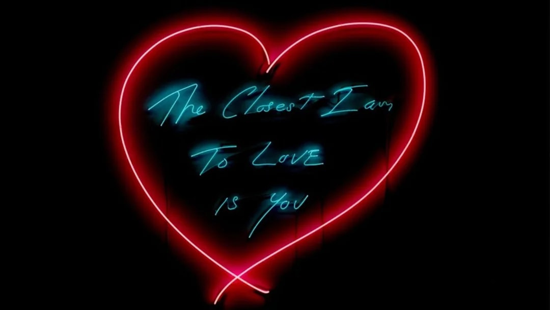 Neon heart artwork with text "The Closest I Am To Love Is You" at Moco Museum London.
