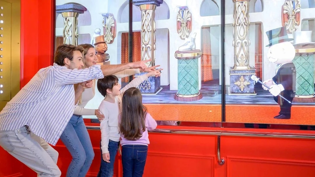 Family enjoying interactive display at Monopoly Dreams Melbourne.