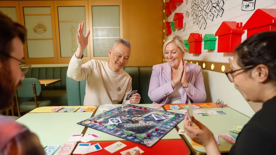 People playing Monopoly Dreams board game in Melbourne attraction.