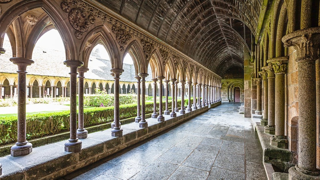 Cloister arches inside Mont Saint Michel abbey, Normandy, France.