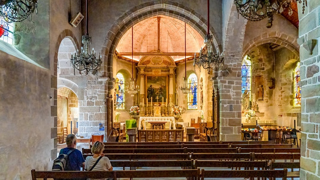 Interior of Church of Saint Pierre with altar and stained glass, Mont Saint Michel tour.