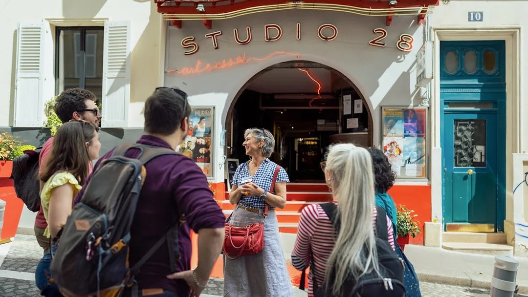 Tour group outside Studio 28 in Montmartre during Sacré Coeur walking tour.