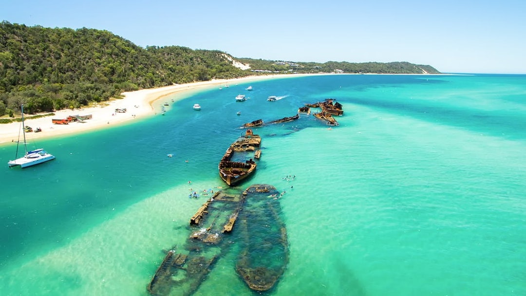 Aerial view of shipwrecks in turquoise waters off Moreton Island, Queensland, Australia.