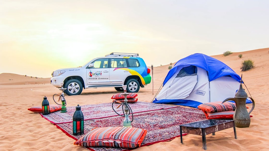 Desert campsite with tent, 4x4 vehicle, and traditional setup for Morning Desert Safari.