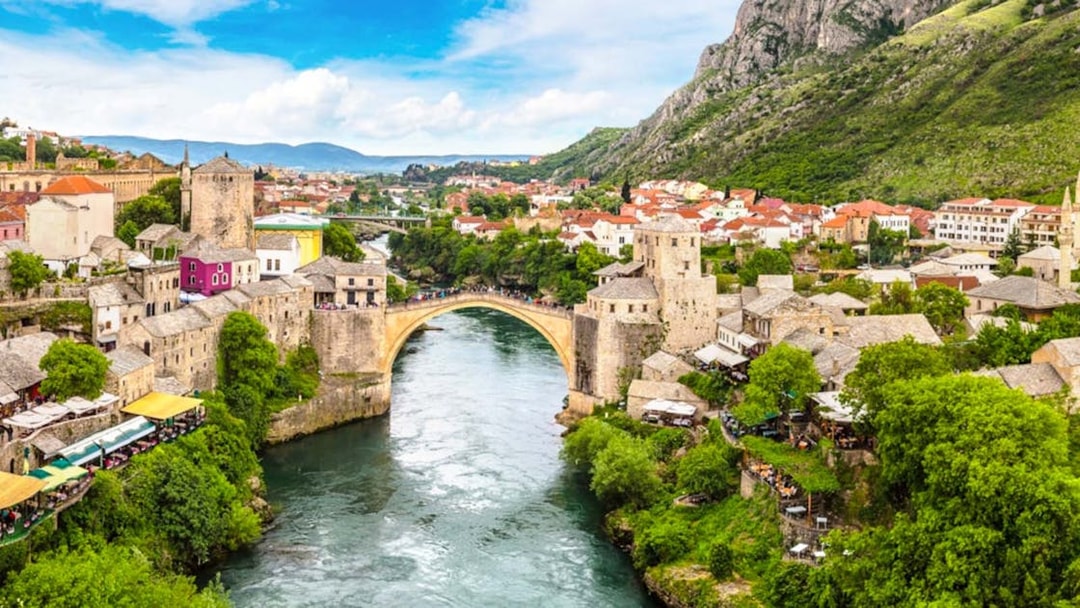 Stari Most bridge over Neretva River in Mostar, Bosnia and Herzegovina, with surrounding town.