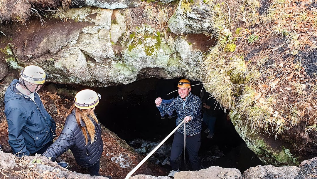 Tourists entering a cave during Mount Etna exploration tour.