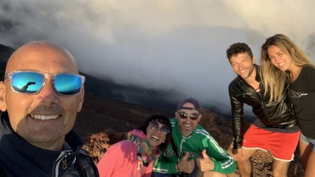 Group enjoying Mount Etna Jeep tour with wine tasting, Sicily.
