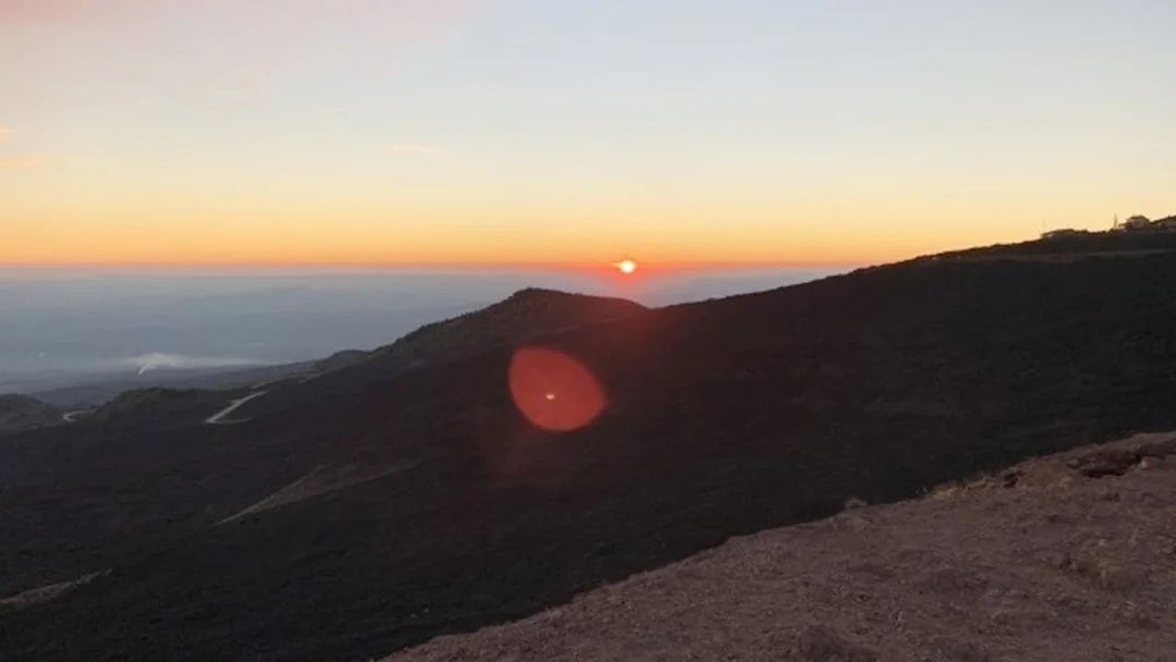 Sunset view over Mount Etna's rugged landscape during a Jeep tour.