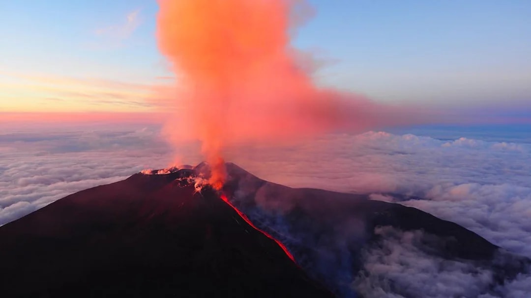 Mount Etna erupting with smoke and lava flow, Catania, Italy.