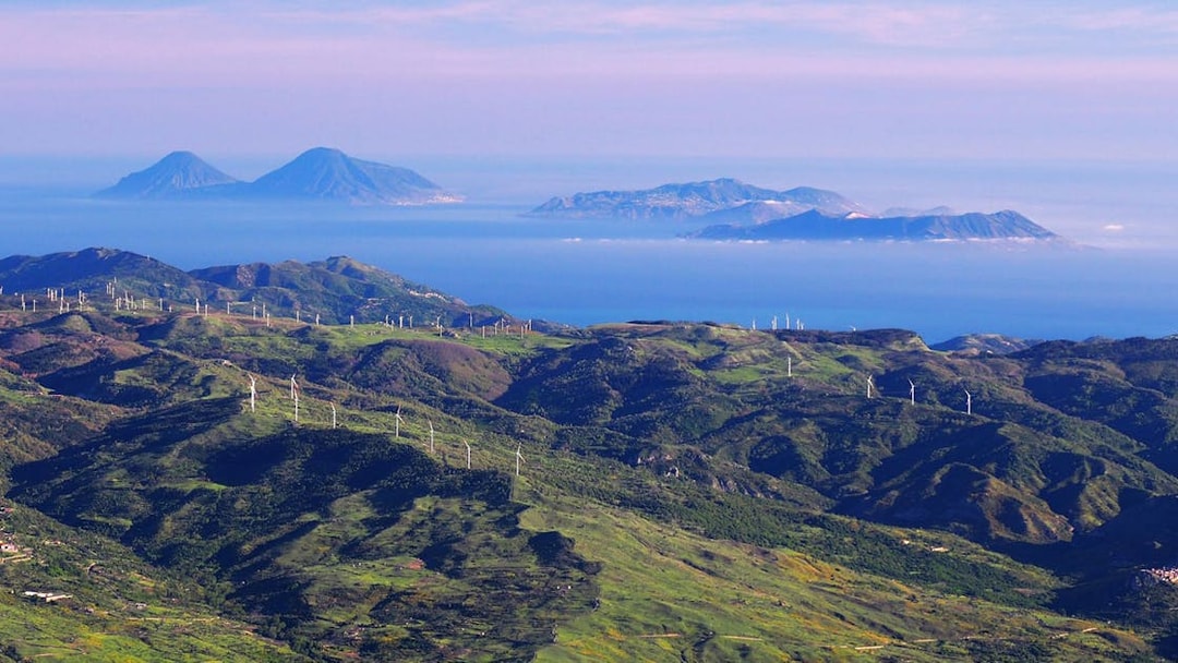 Mount Etna landscape with wind turbines and distant islands, Sicily Jeep tour.