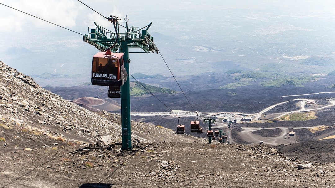 Mount Etna cable car ascending volcanic landscape in Sicily.