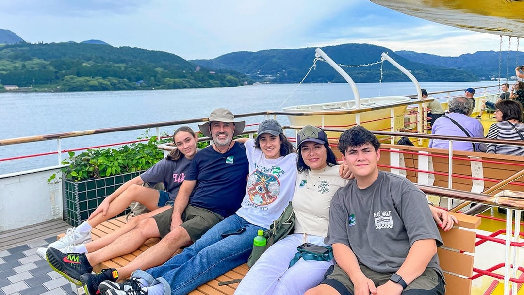 Group enjoying a boat ride on Lake Ashi with Mount Fuji in the background, part of the Fuji & Hakone tour.