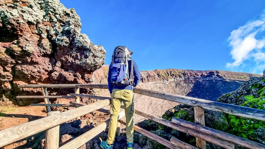 Hiker overlooking Mount Vesuvius crater in Naples, Italy.