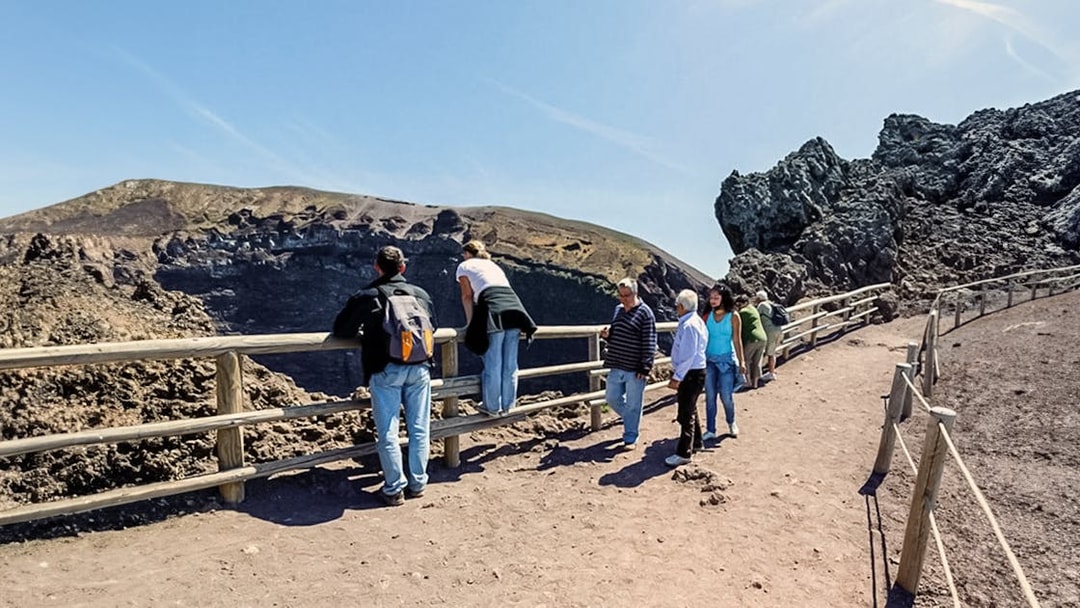 Tourists walking along a hiking trail at Mount Vesuvius, Italy.