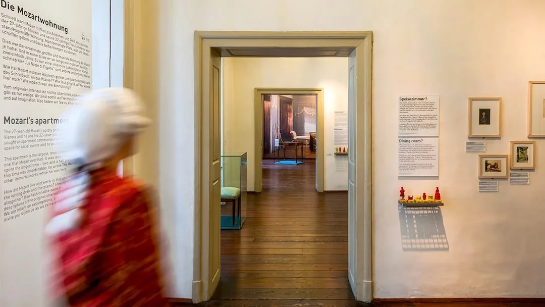 Mozarthaus interior hallway with informational displays and framed pictures.