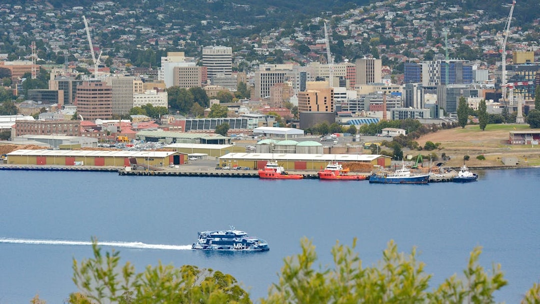 Hobart waterfront view with ferry en route to MONA, Mt Wellington in background.