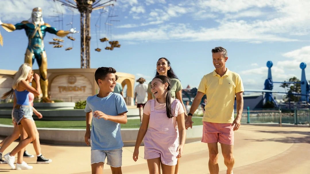 Tourists walking past Leviathan statue at Sea World.