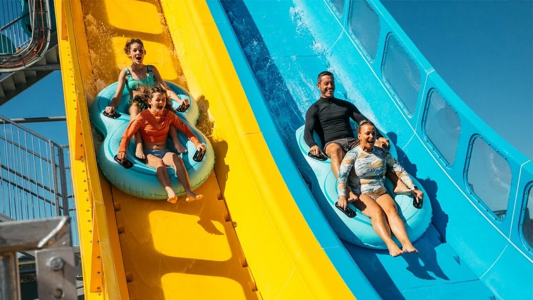 Tourists sliding down water slides at Kaboom, Wet n Wild.