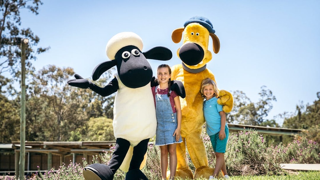 Children posing with animal mascots at Paradise Country.