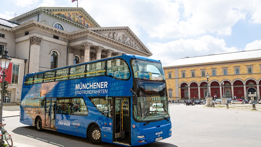 Double-decker bus in front of Munich's National Theatre on a city tour.