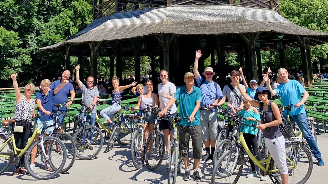 Group of cyclists at the Chinese Tower in Munich's English Garden during a bike tour.