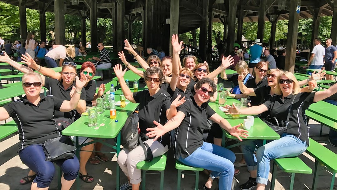 Group enjoying a break at a beer garden during Munich bike tour.