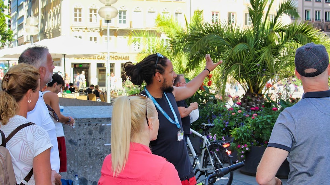 Tour guide leading a group on a Munich bike tour, pointing out city landmarks.