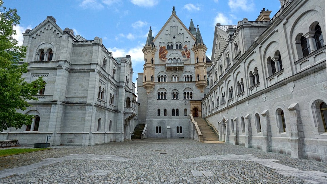 Neuschwanstein Castle courtyard with ornate architecture on a day trip from Munich.