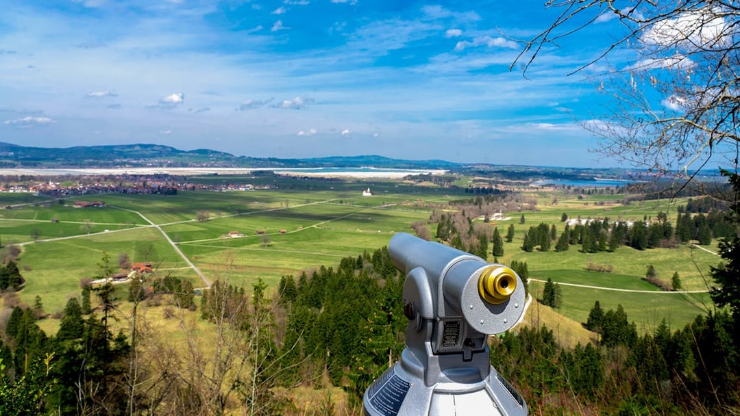 Viewing scope overlooking Bavarian countryside near Neuschwanstein Castle.