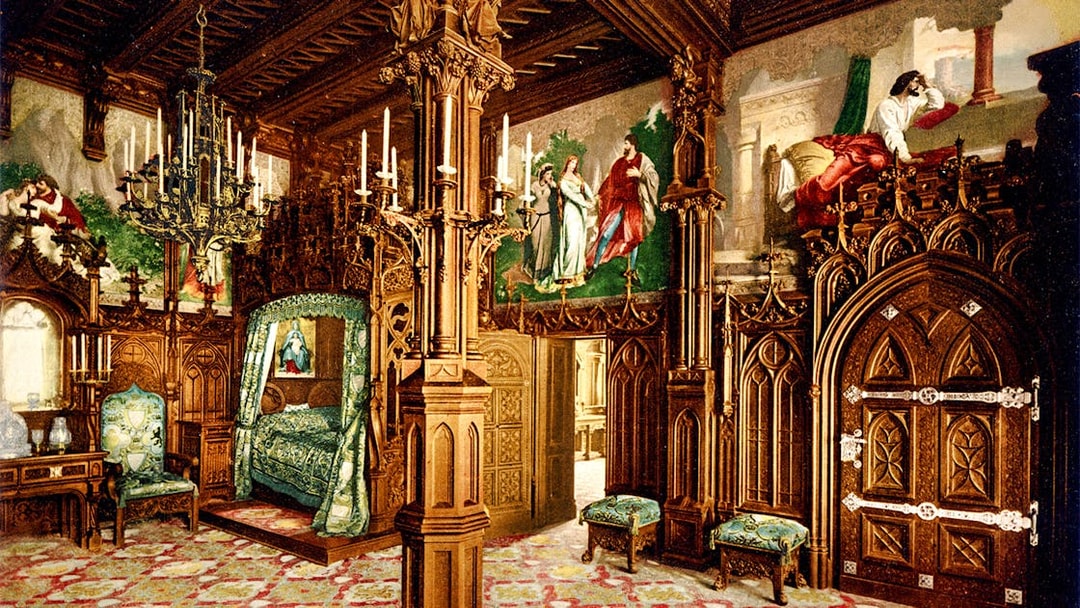 Neuschwanstein Castle interior with ornate wooden carvings and colorful murals.