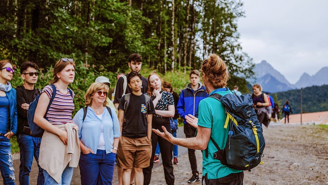 Tour group listening to a guide near Neuschwanstein Castle, Germany.