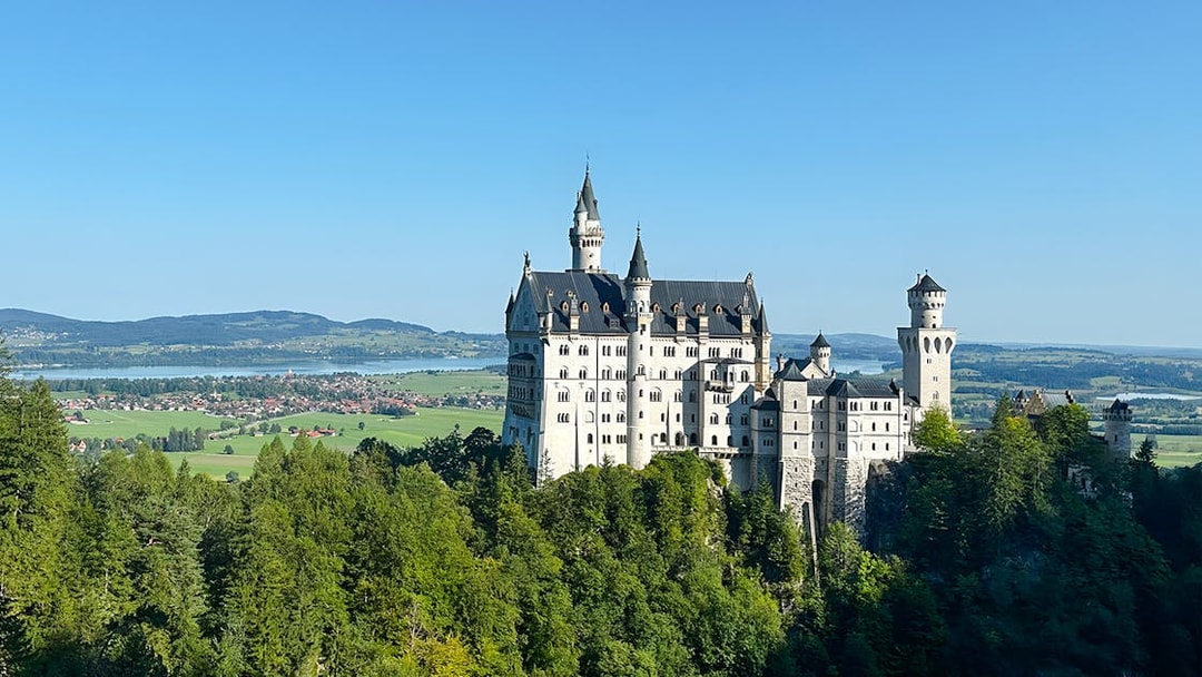 Neuschwanstein Castle surrounded by lush greenery, view from the full-day tour from Munich.