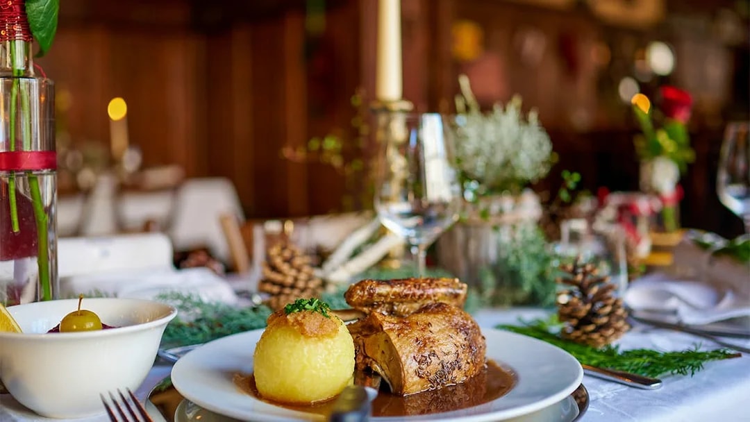 Roast chicken and potato dumpling on a table set for a meal during the Neuschwanstein Castle tour.