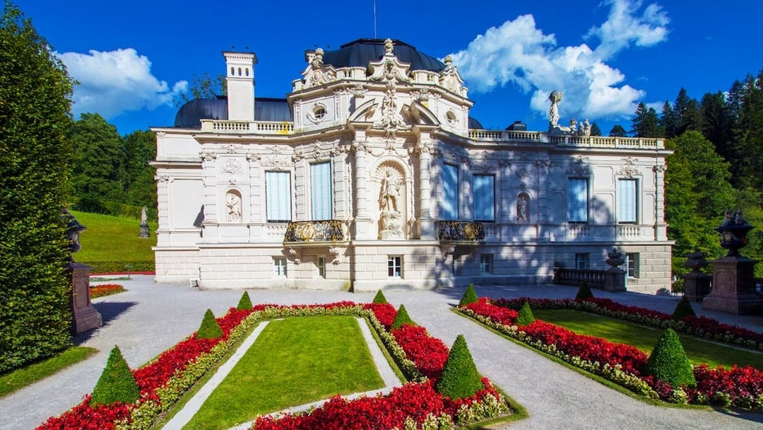 Linderhof Palace with ornate facade and manicured gardens, Germany.