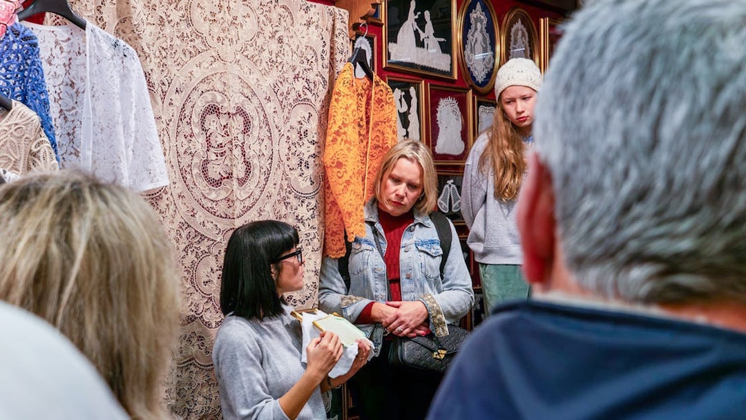 Tour group observing lace-making demonstration at Lace Museum in Burano.