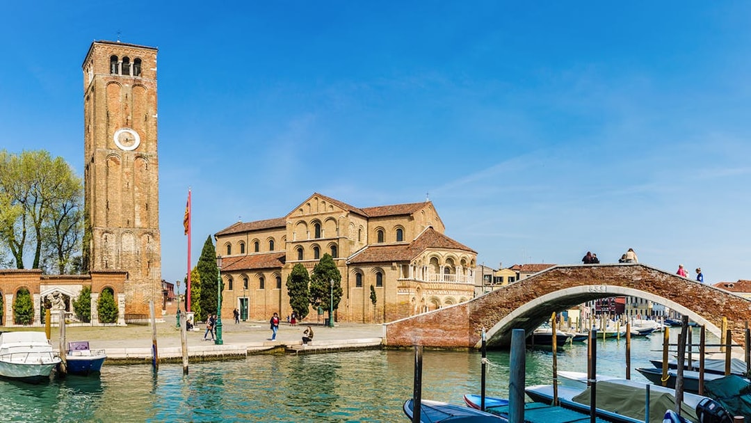 Murano Basilica dei Santi Maria e Donato with canal and boats in foreground.