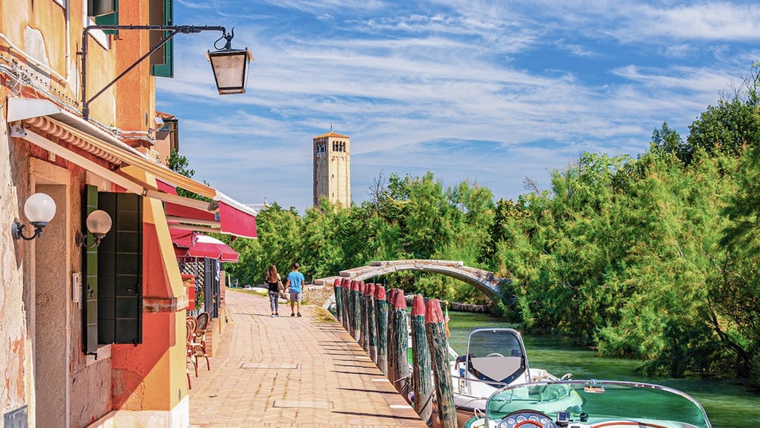 Torcello Island's Devil Bridge with nearby canal and walking path.