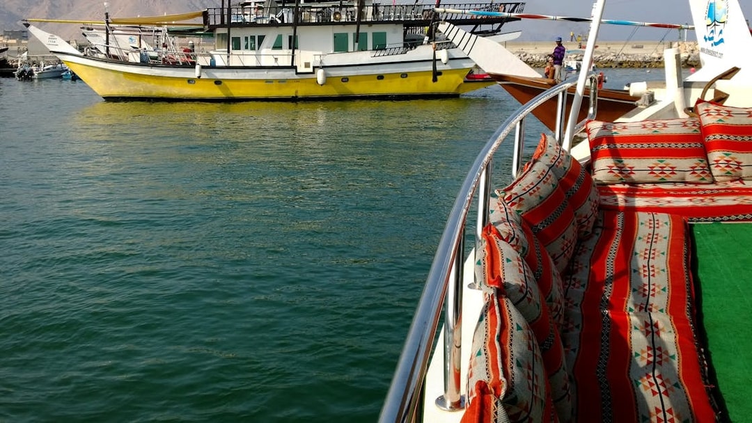 Dhow boat with colorful seating on Musandam Dibba tour, Oman.