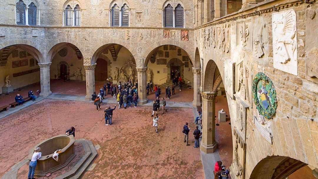 Visitors exploring the historic courtyard of Museo del Bargello in Florence.