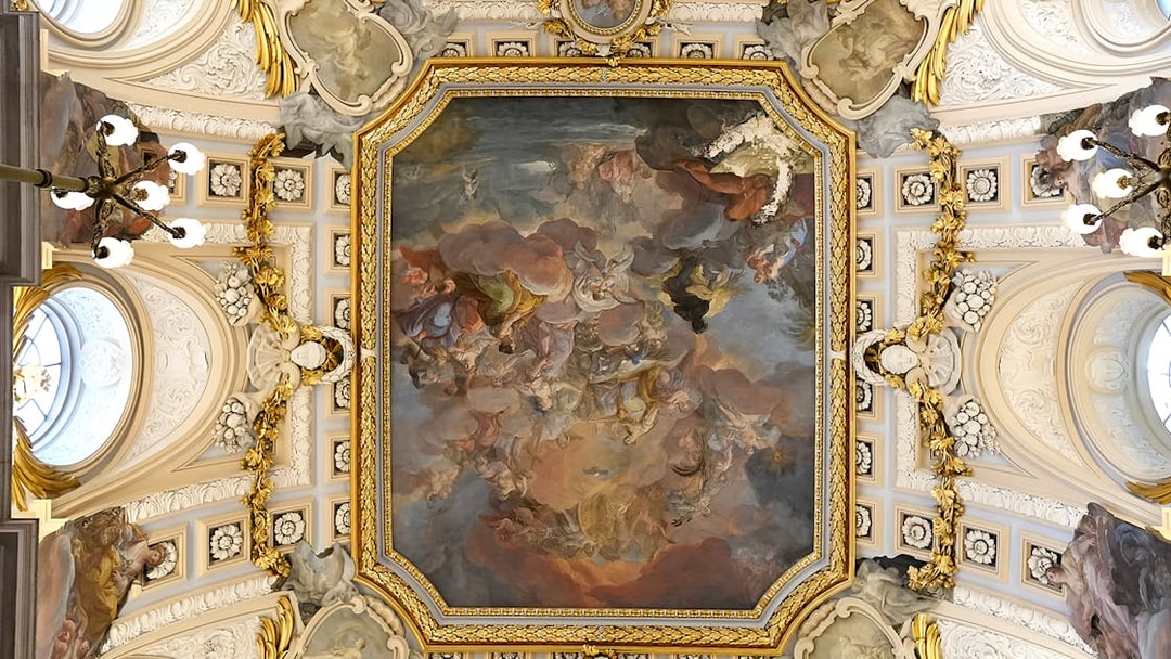 Ceiling fresco and ornate details in the Royal Palace of Madrid during a guided tour.