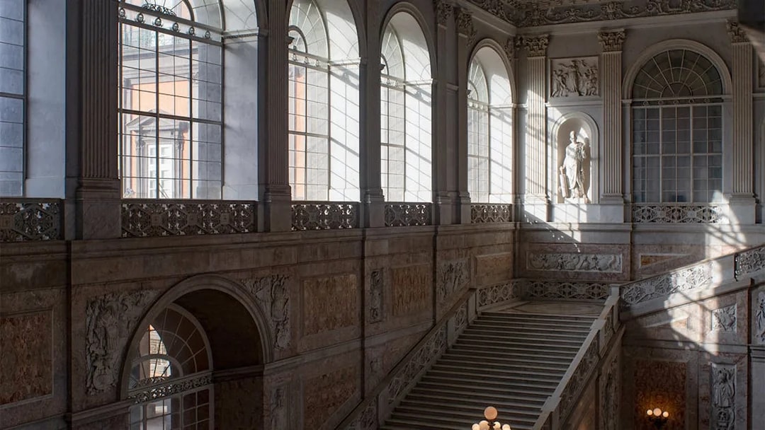 Grand staircase and arched windows inside Museo di Capodimonte, Naples.