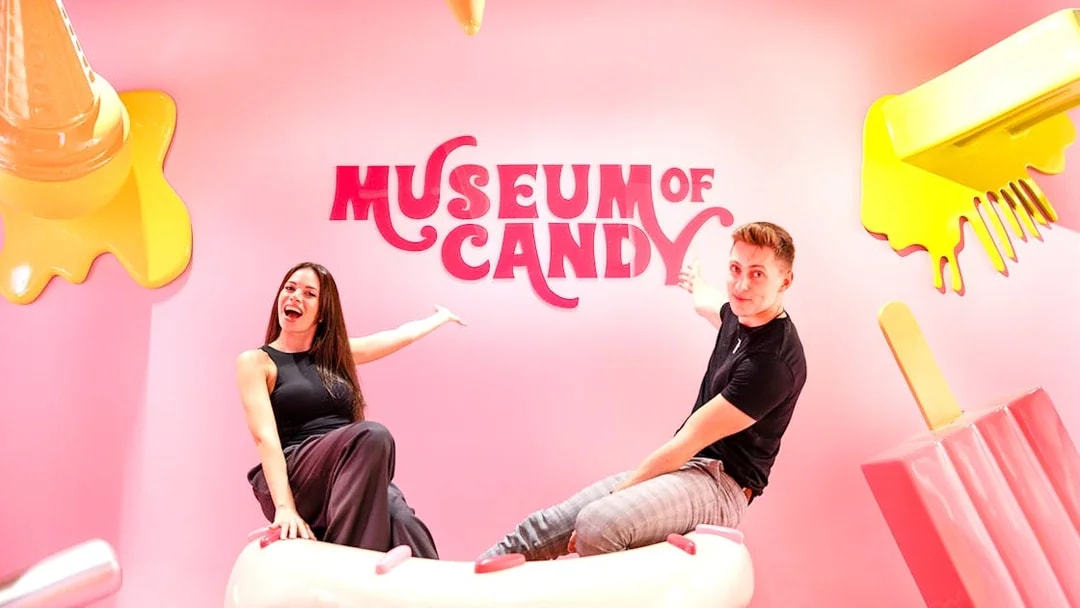 Visitors on cupcake prop at Museum of Candy, Dubai.
