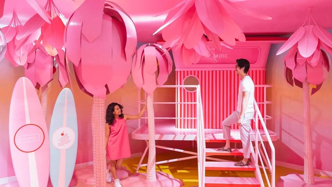 Visitors exploring vibrant pink room at Museum of Ice Cream, Singapore.