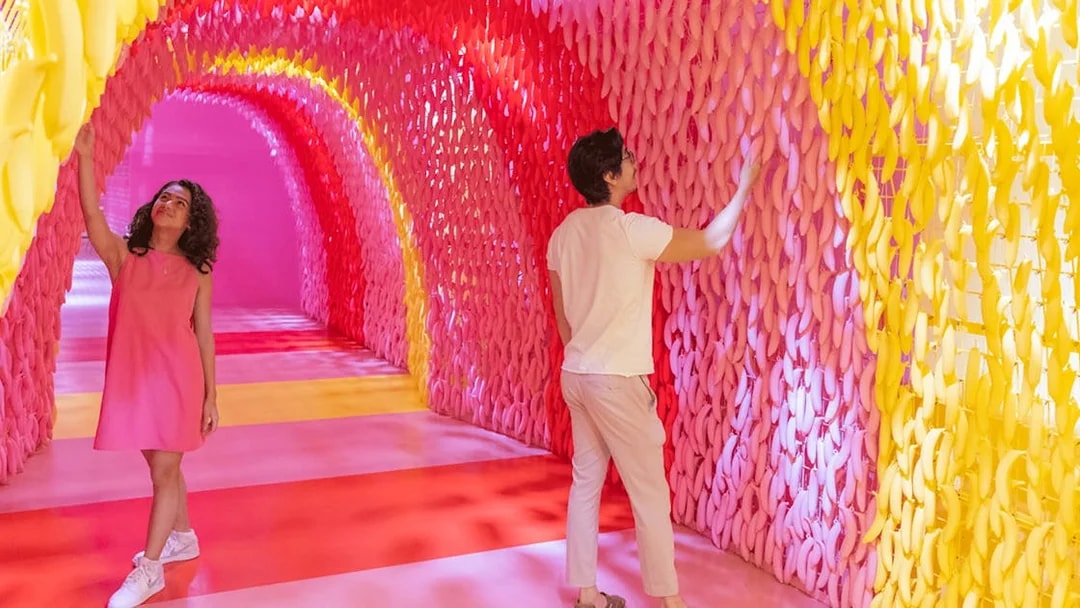 Visitors exploring colorful banana exhibit at Museum of Ice Cream Singapore.