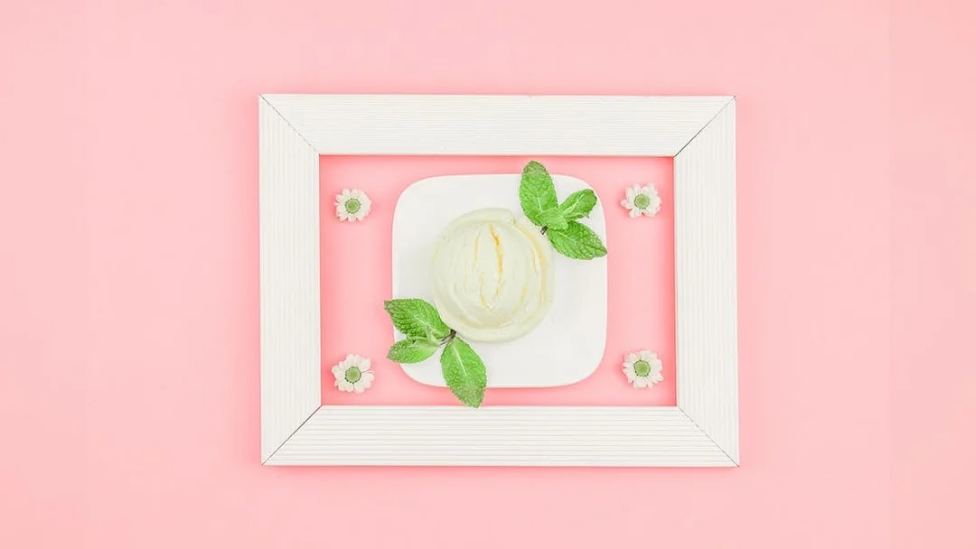Ice cream scoop with mint leaves on a plate at Singapore's Museum of Ice Cream.