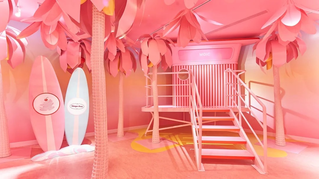 Museum of Ice Cream Singapore pink room with surfboards and palm trees.