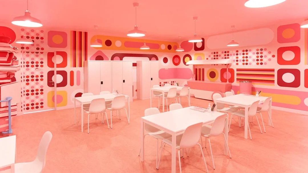 Colorful room with geometric patterns and tables at Museum of Ice Cream Singapore.